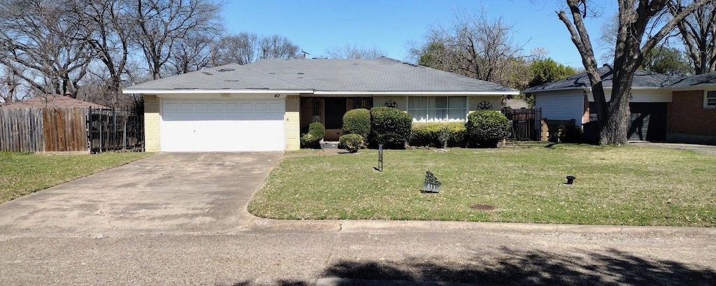 ranch-style house featuring fence, driveway, an attached garage, a front lawn, and brick siding