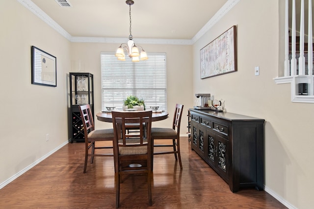 dining room with an inviting chandelier, crown molding, baseboards, and dark wood-style flooring