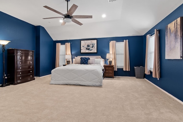 carpeted bedroom with visible vents, lofted ceiling, baseboards, and ceiling fan