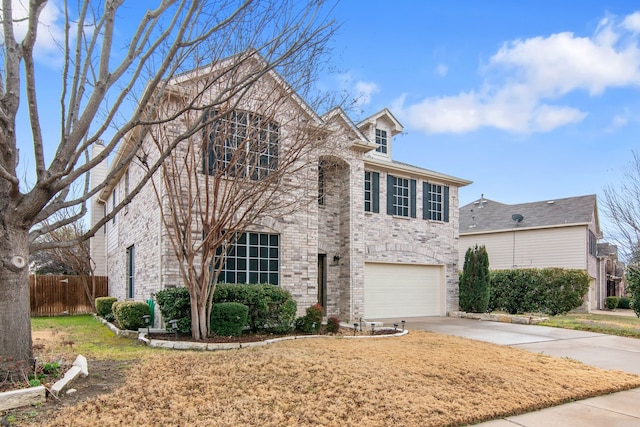 traditional-style home with concrete driveway, a garage, fence, and brick siding