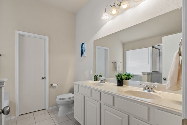 full bathroom featuring a sink, toilet, double vanity, and tile patterned floors