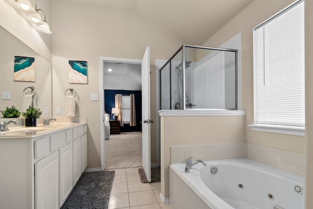 ensuite bathroom with tile patterned floors, a stall shower, a sink, a whirlpool tub, and vaulted ceiling