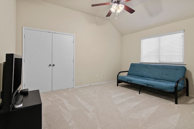 living area featuring baseboards, a ceiling fan, lofted ceiling, and carpet floors