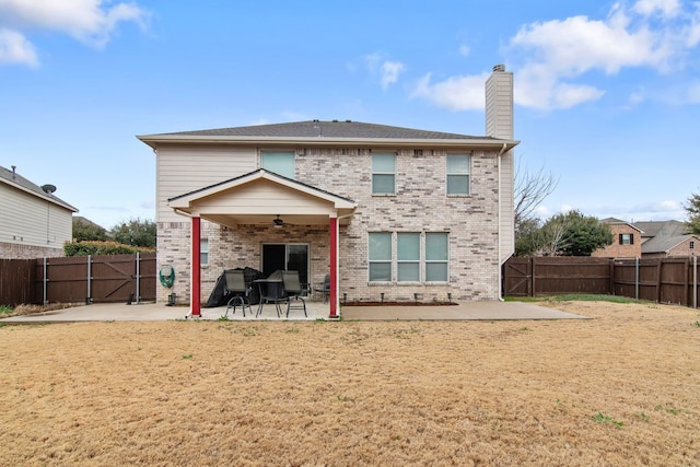 back of property with a patio, a ceiling fan, brick siding, and a fenced backyard