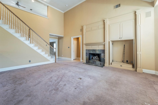 unfurnished living room with stairway, visible vents, baseboards, crown molding, and light colored carpet