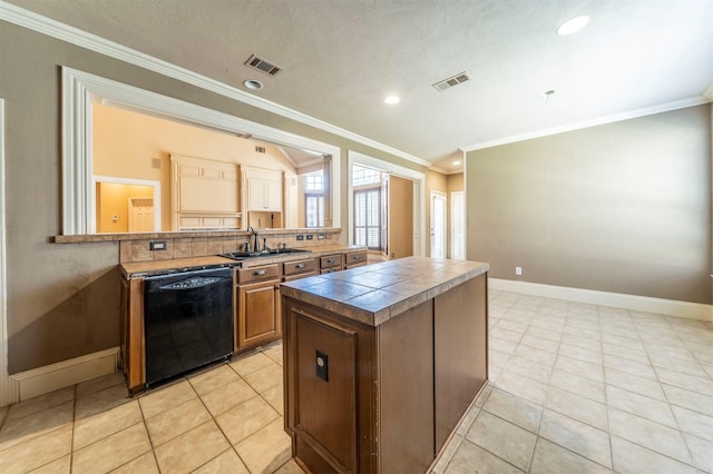 kitchen with a sink, visible vents, black dishwasher, and crown molding