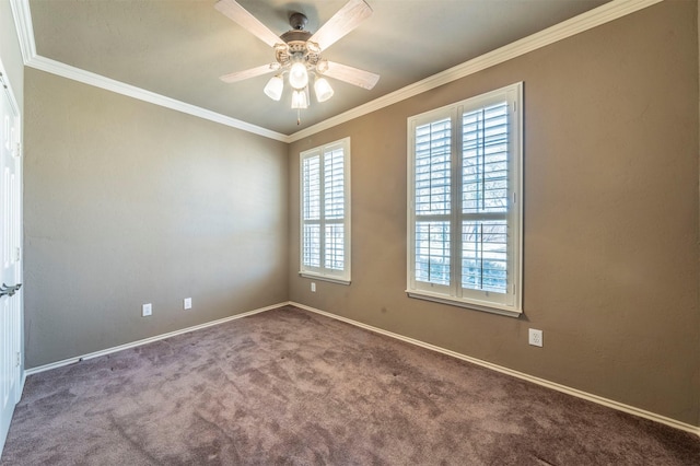 carpeted spare room with baseboards, crown molding, and a ceiling fan