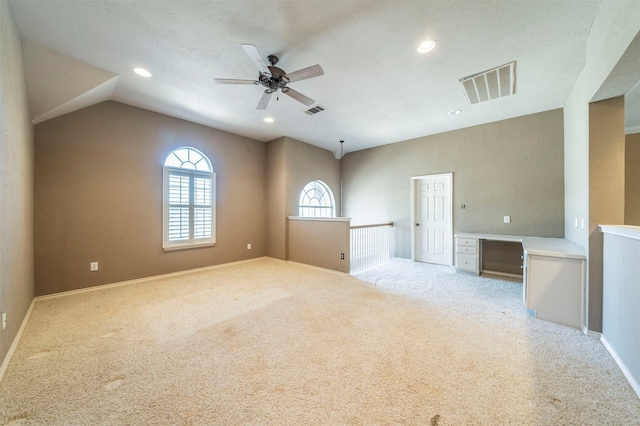 empty room with recessed lighting, visible vents, light carpet, and lofted ceiling