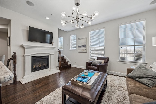 7917 Parkwood Blvd, Plano, TX 75024 - living room featuring wood finished floors, baseboards, a fireplace, and stairway