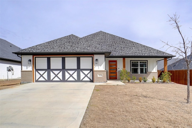 view of front of home featuring fence, concrete driveway, a shingled roof, a garage, and brick siding