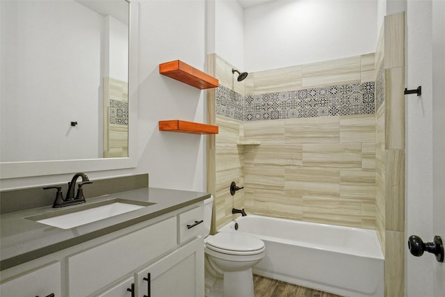 full bath with shower / bathing tub combination, toilet, wood finished floors, and vanity