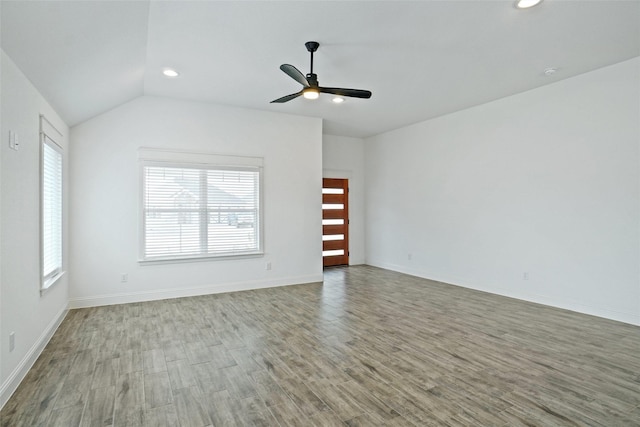 spare room featuring vaulted ceiling, recessed lighting, a ceiling fan, and wood finished floors