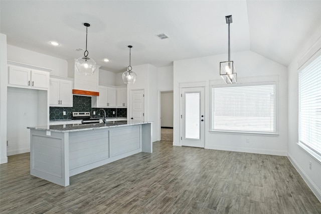 kitchen featuring visible vents, wood finished floors, white cabinets, decorative backsplash, and light stone countertops