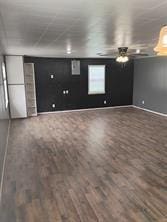 interior space featuring wood finished floors and a ceiling fan