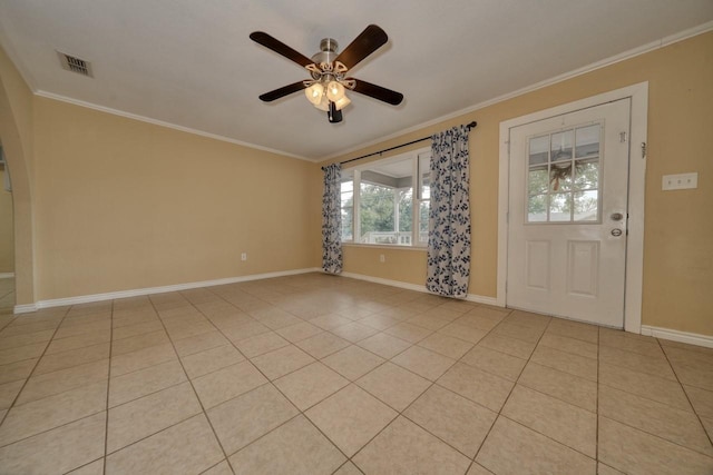 foyer entrance with light tile patterned floors, a ceiling fan, baseboards, and ornamental molding