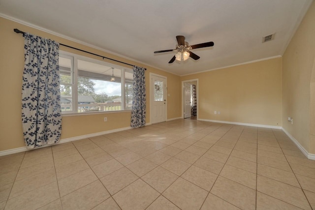 unfurnished room with light tile patterned floors, visible vents, crown molding, and baseboards