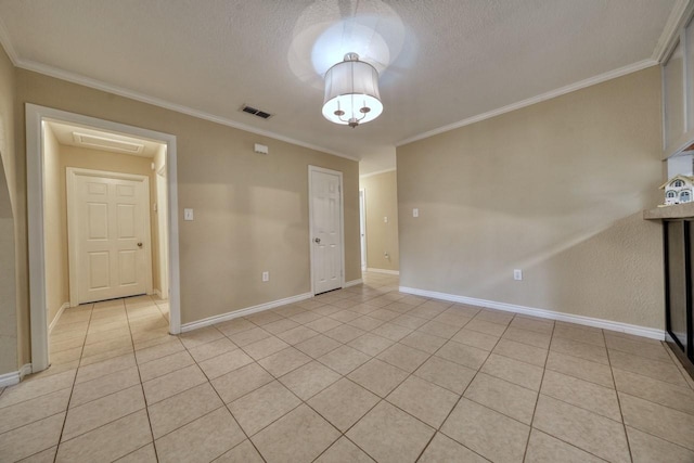 unfurnished room with light tile patterned floors, visible vents, a textured ceiling, and crown molding