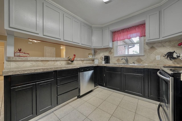 kitchen featuring decorative backsplash, a peninsula, a sink, and stainless steel appliances