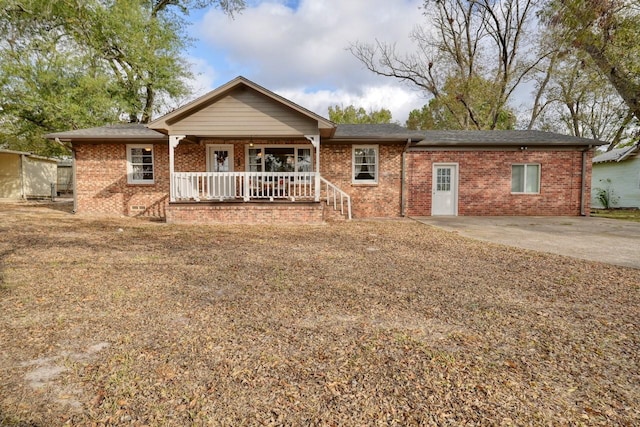 single story home with brick siding and a porch