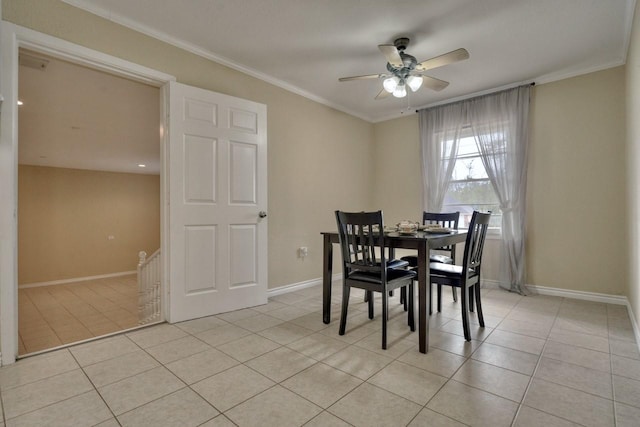 dining space featuring light tile patterned floors, baseboards, and ornamental molding