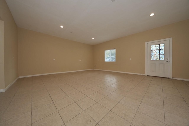 spare room featuring recessed lighting, baseboards, and light tile patterned flooring