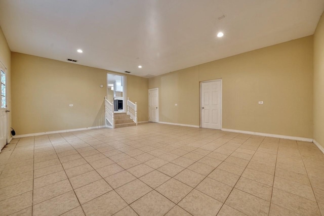 unfurnished room featuring visible vents, baseboards, stairs, light tile patterned floors, and recessed lighting