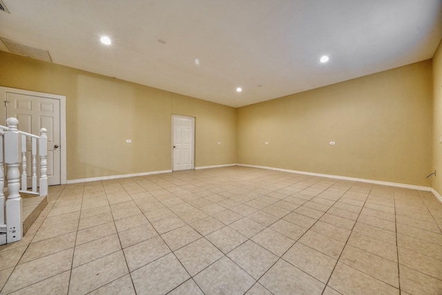 spare room featuring light tile patterned floors, recessed lighting, and baseboards