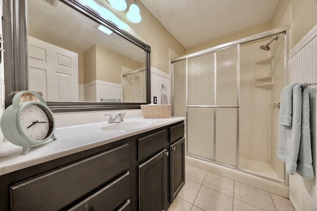 bathroom featuring vanity, tile patterned floors, and a shower stall