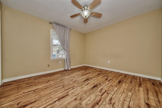 unfurnished room featuring ceiling fan, baseboards, and light wood-style flooring