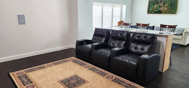 home theater room with baseboards and wood finished floors