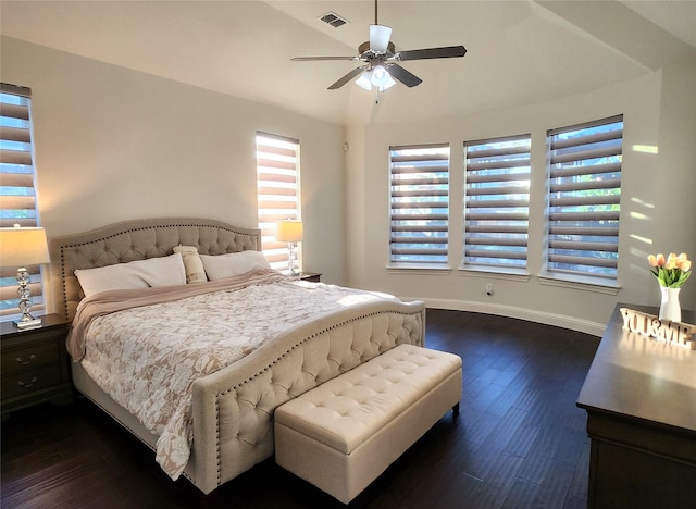 bedroom with dark wood-type flooring, baseboards, visible vents, and ceiling fan