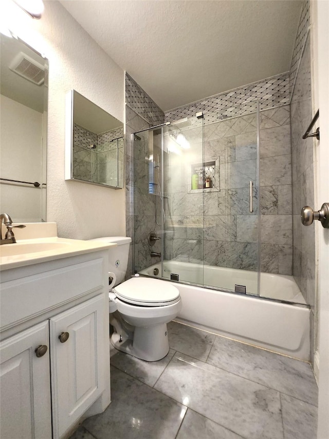 bathroom with visible vents, toilet, enclosed tub / shower combo, vanity, and a textured wall