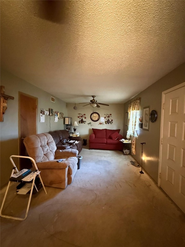 living room with visible vents, a textured ceiling, ceiling fan, and carpet