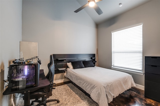 bedroom with baseboards, lofted ceiling, and a ceiling fan