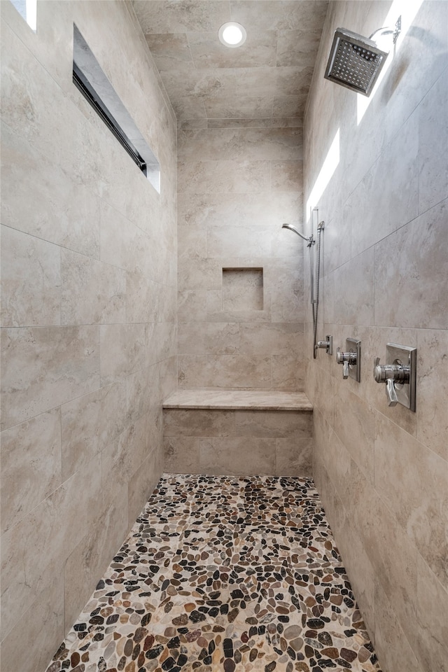 bathroom with a tile shower