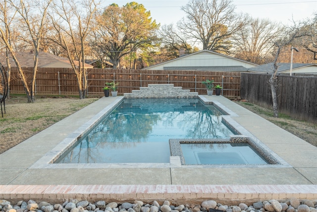 view of pool featuring a pool with connected hot tub and a fenced backyard