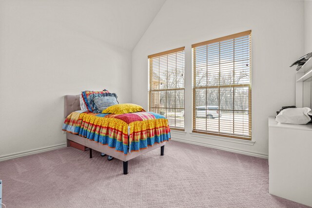 bedroom featuring baseboards, multiple windows, carpet, and lofted ceiling