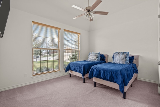 carpeted bedroom with ceiling fan, baseboards, and vaulted ceiling