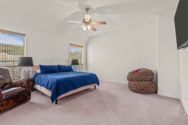 carpeted bedroom with lofted ceiling, baseboards, and ceiling fan