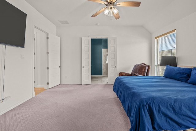 bedroom featuring visible vents, baseboards, vaulted ceiling, light carpet, and a ceiling fan