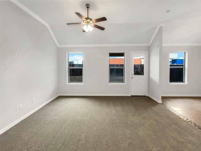 interior space with baseboards, lofted ceiling, a ceiling fan, and crown molding