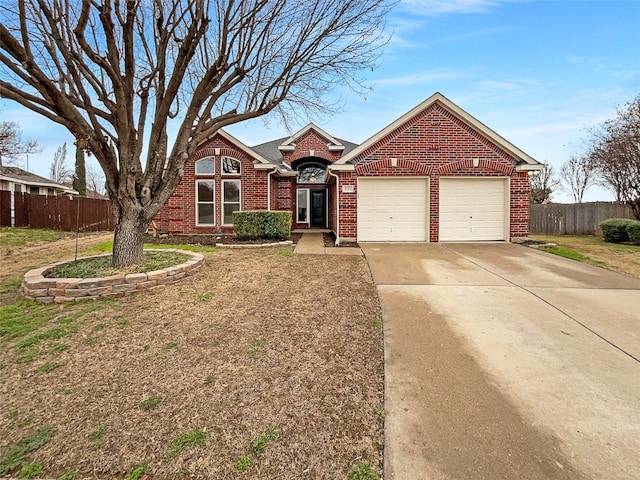 view of front facade featuring concrete driveway, a garage, fence, and brick siding