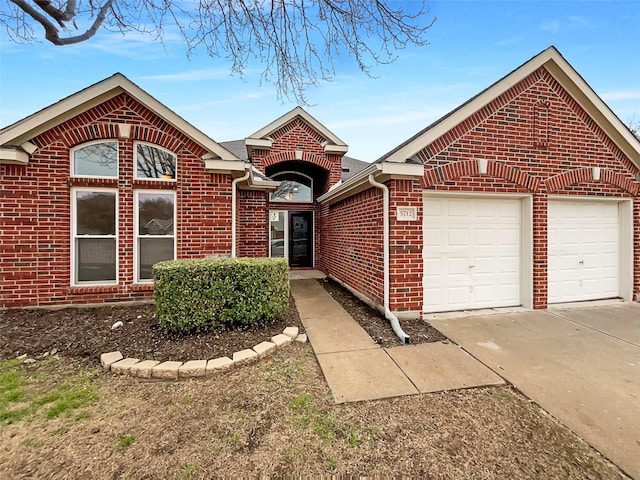 single story home featuring concrete driveway, brick siding, and a garage