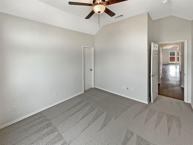 unfurnished bedroom featuring visible vents, lofted ceiling, baseboards, and a ceiling fan