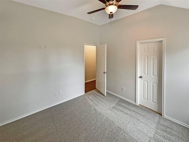 unfurnished bedroom with lofted ceiling, carpet flooring, baseboards, and ceiling fan