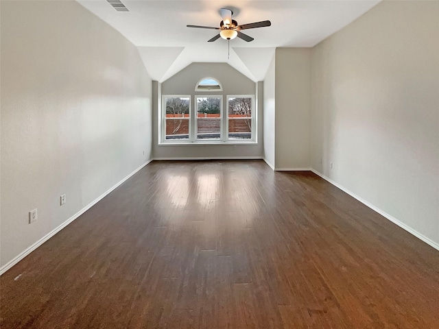 spare room with dark wood-type flooring, baseboards, lofted ceiling, and ceiling fan