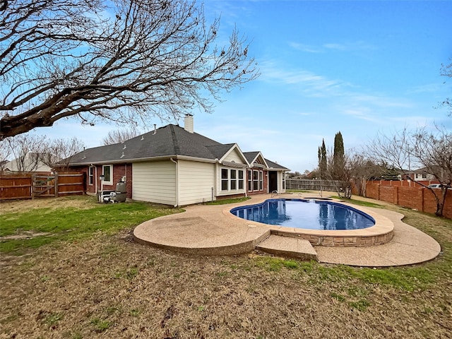 view of swimming pool with a fenced in pool, a patio, a lawn, and a fenced backyard