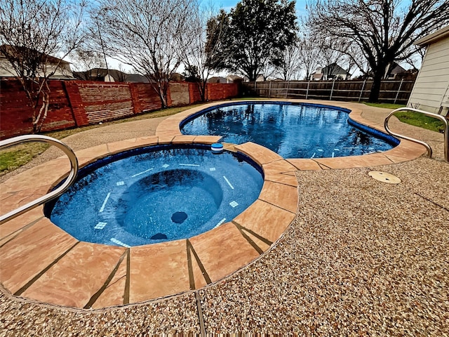 view of pool with a fenced in pool, an in ground hot tub, a fenced backyard, and a patio area