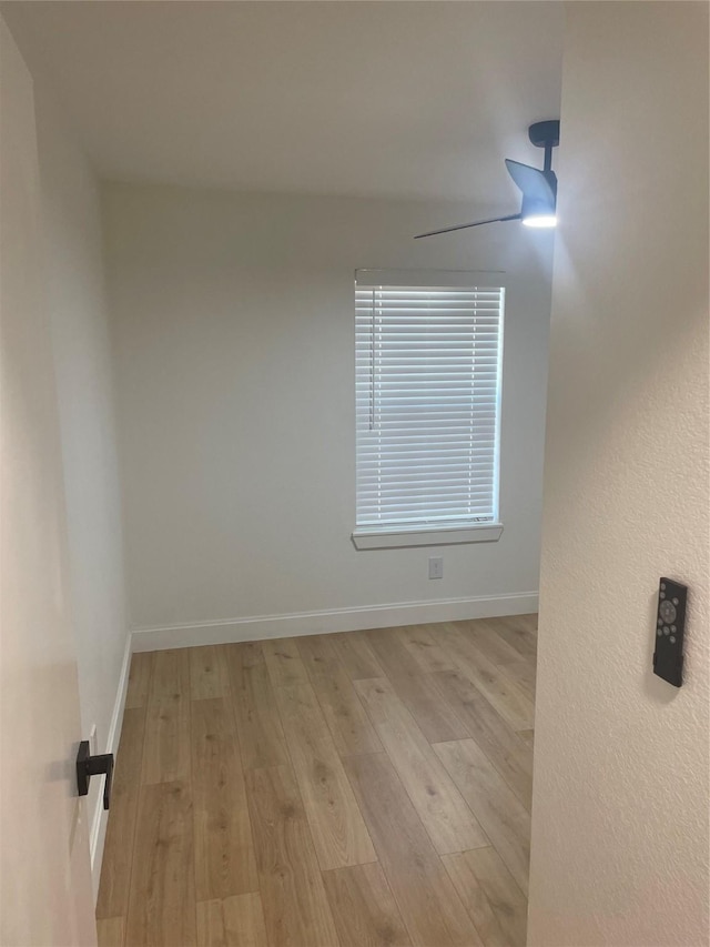 spare room with wood finished floors, baseboards, and ceiling fan