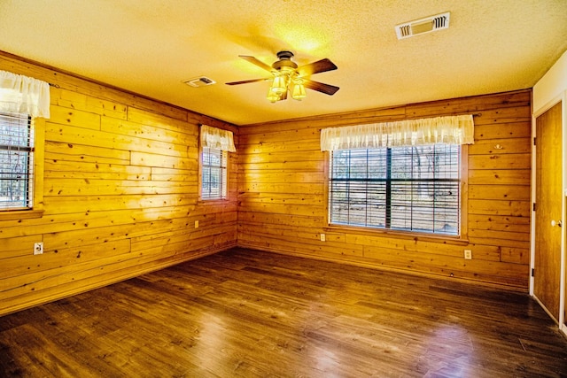 unfurnished room featuring visible vents, ceiling fan, and wood finished floors